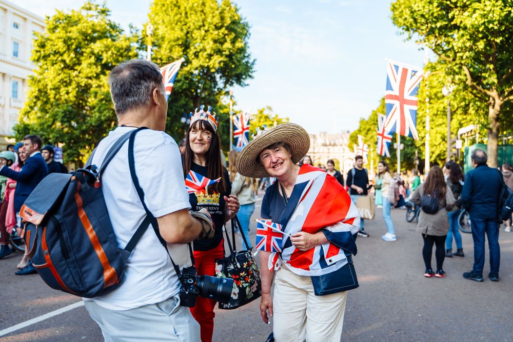 Crowds with Union flags celebrating on The Mall, London